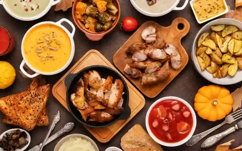 Assorted gourmet dishes served at a Miami restaurant, featuring roasted meats, seasonal vegetables, soups, and fresh sides.